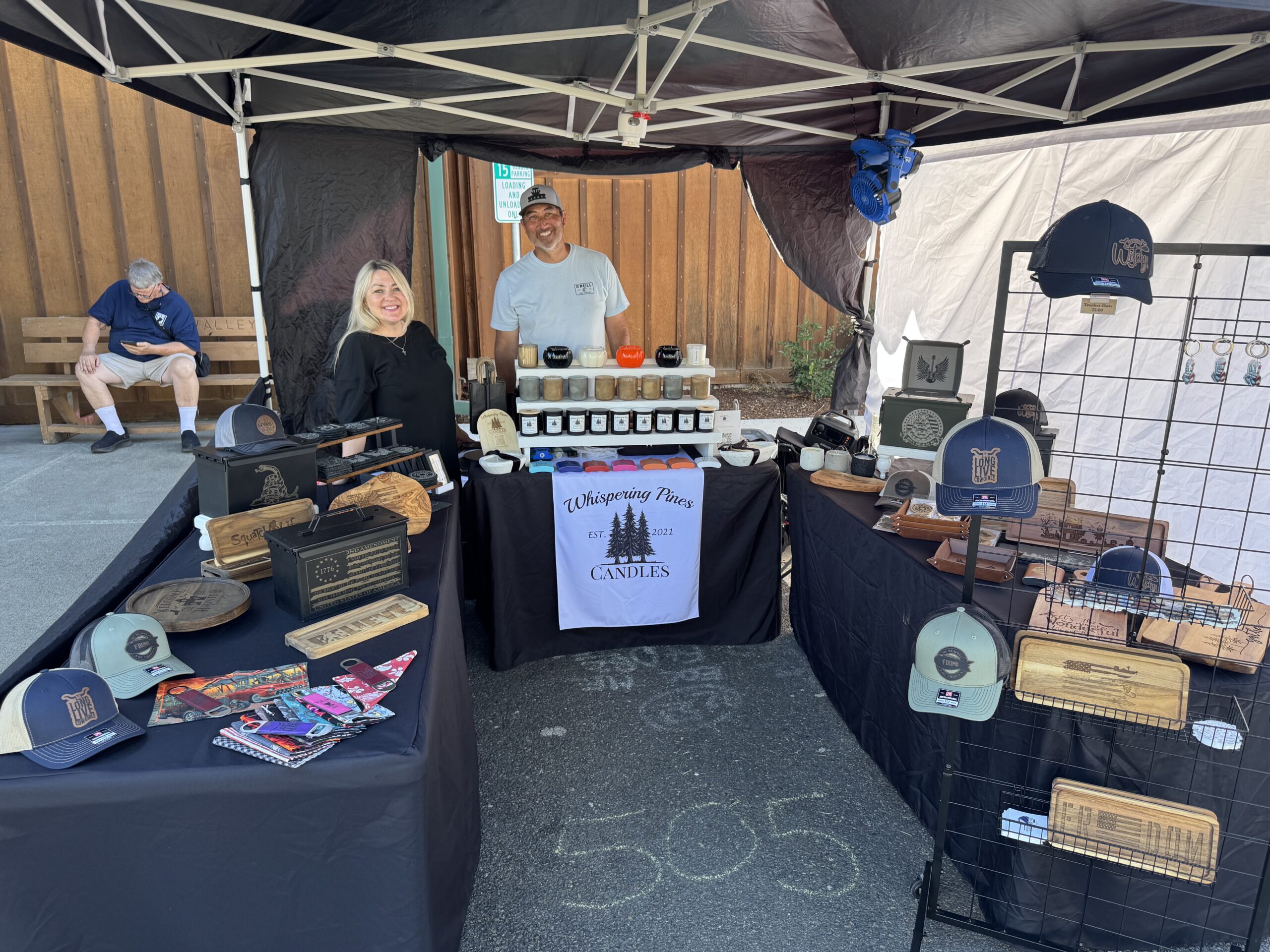 Vendors displaying candles, hats and wooden crafts at the Fair.