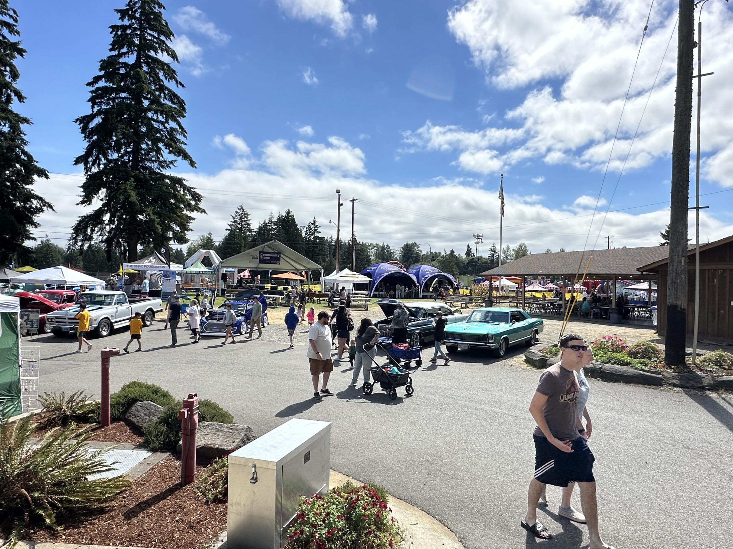 Visitors explore classic cars and activity booths at the Pierce County Fair.